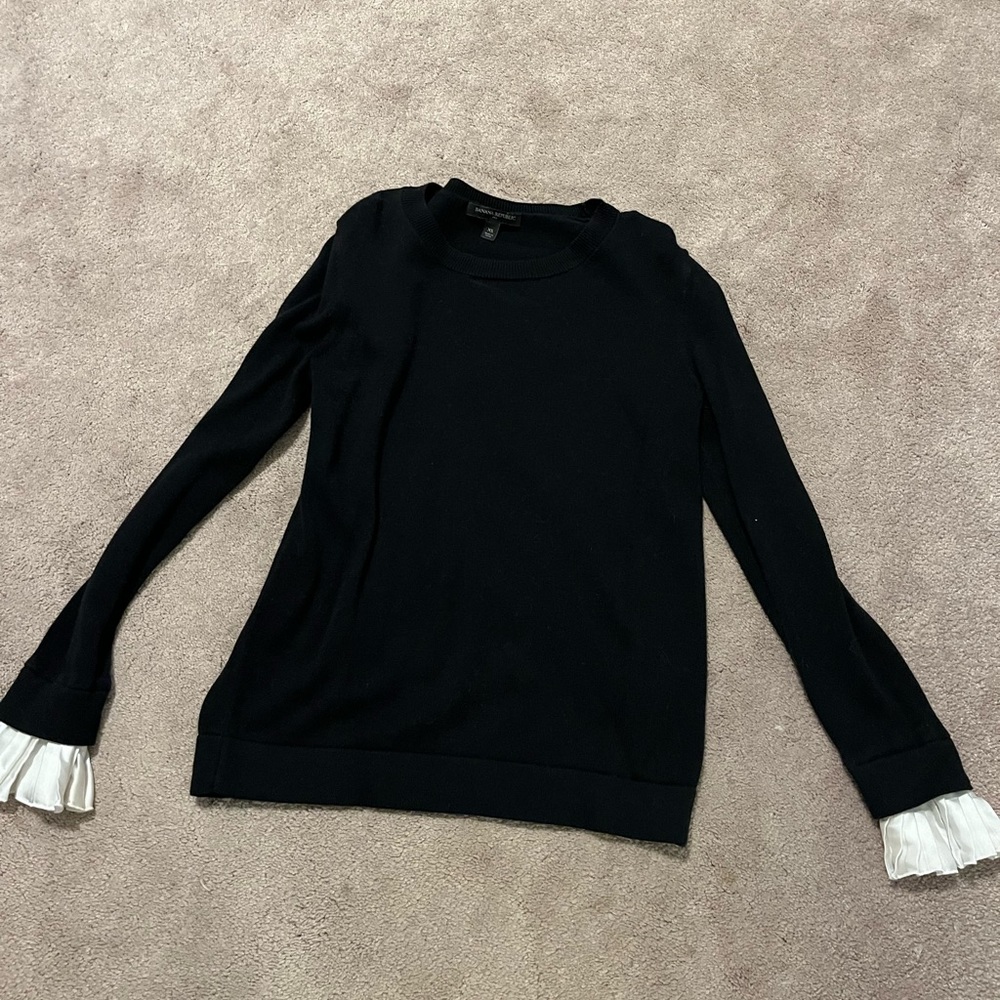 Banana Republic black sweater with cream ruffle sleeves.